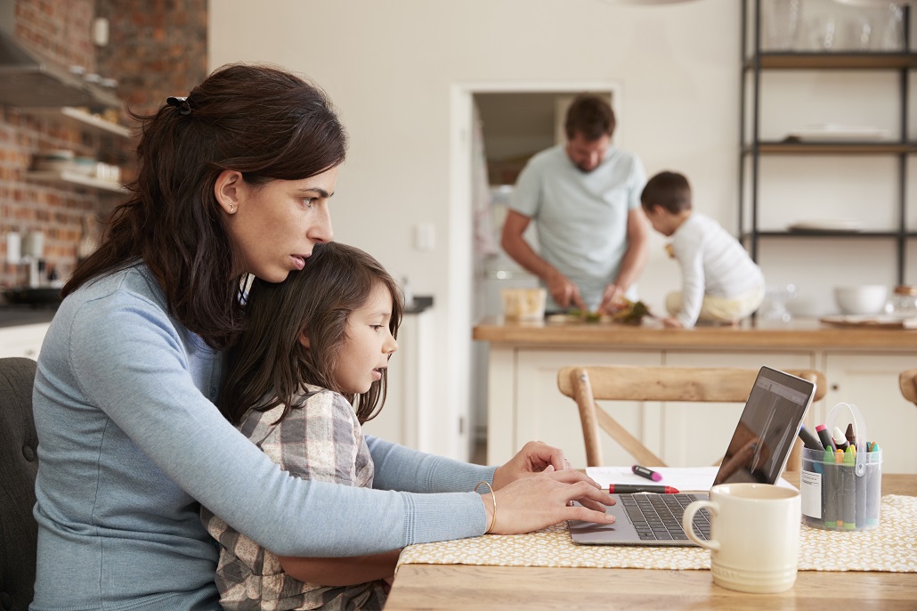 Mother and son using computer together 