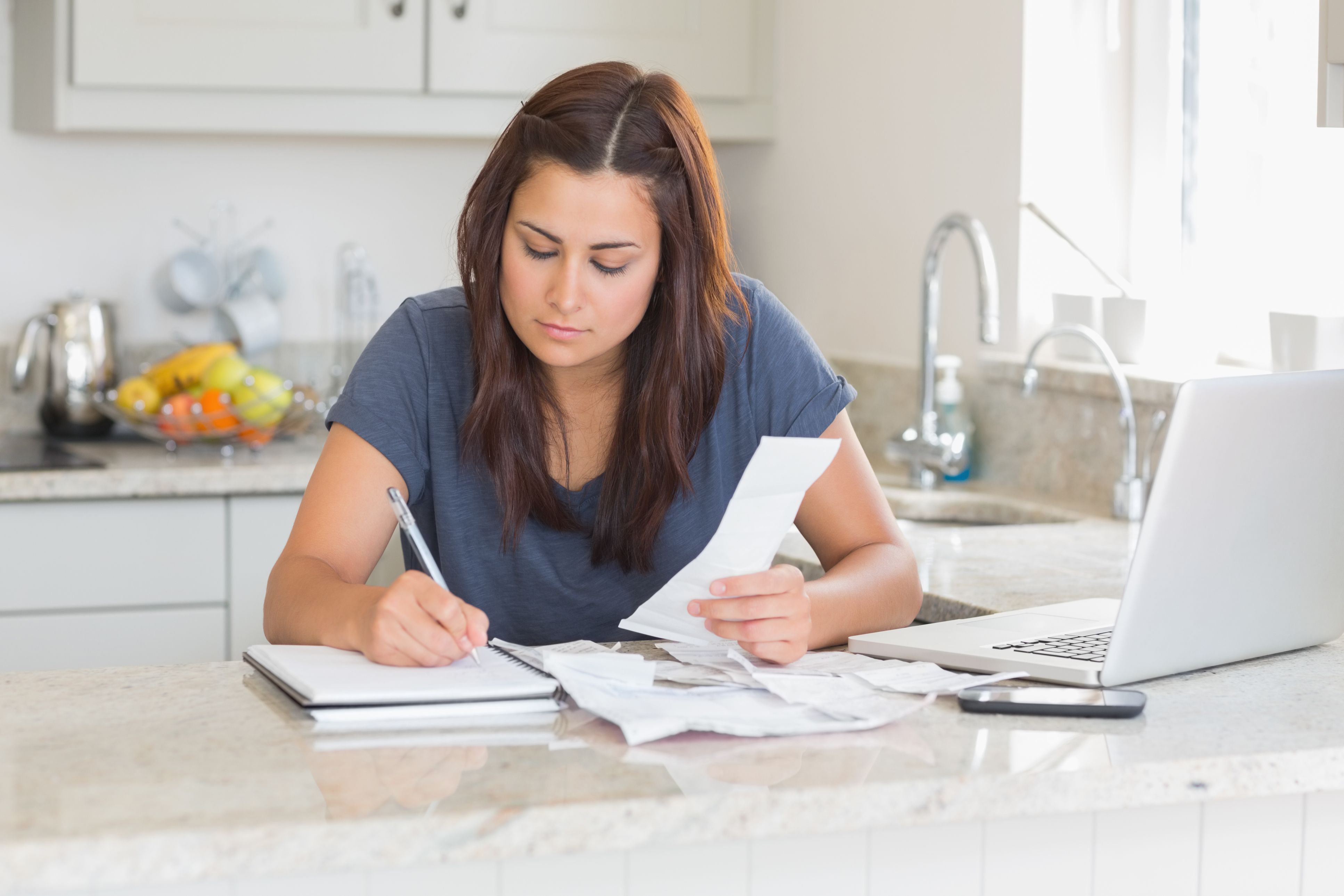 A woman using her laptop to sign up for a college payment plan