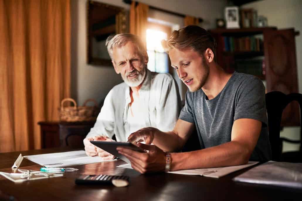 Two men consulting a tablet