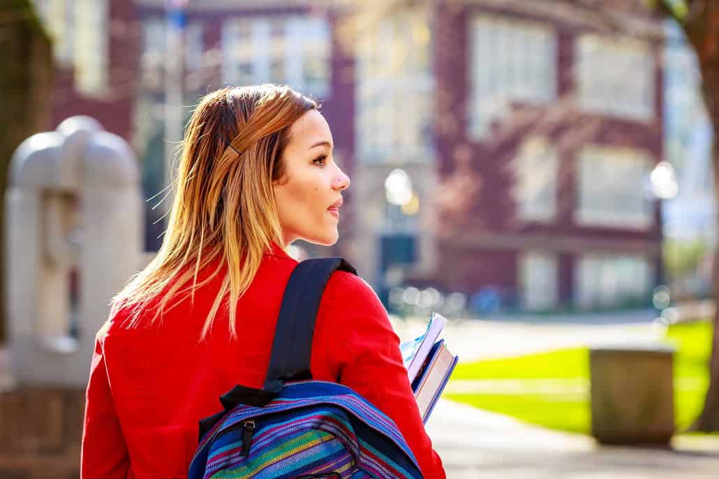 Girl with backpack walking at school