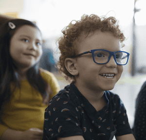 Curly hair kid with glasses