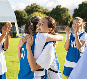 Students congratulating each other in soccer game