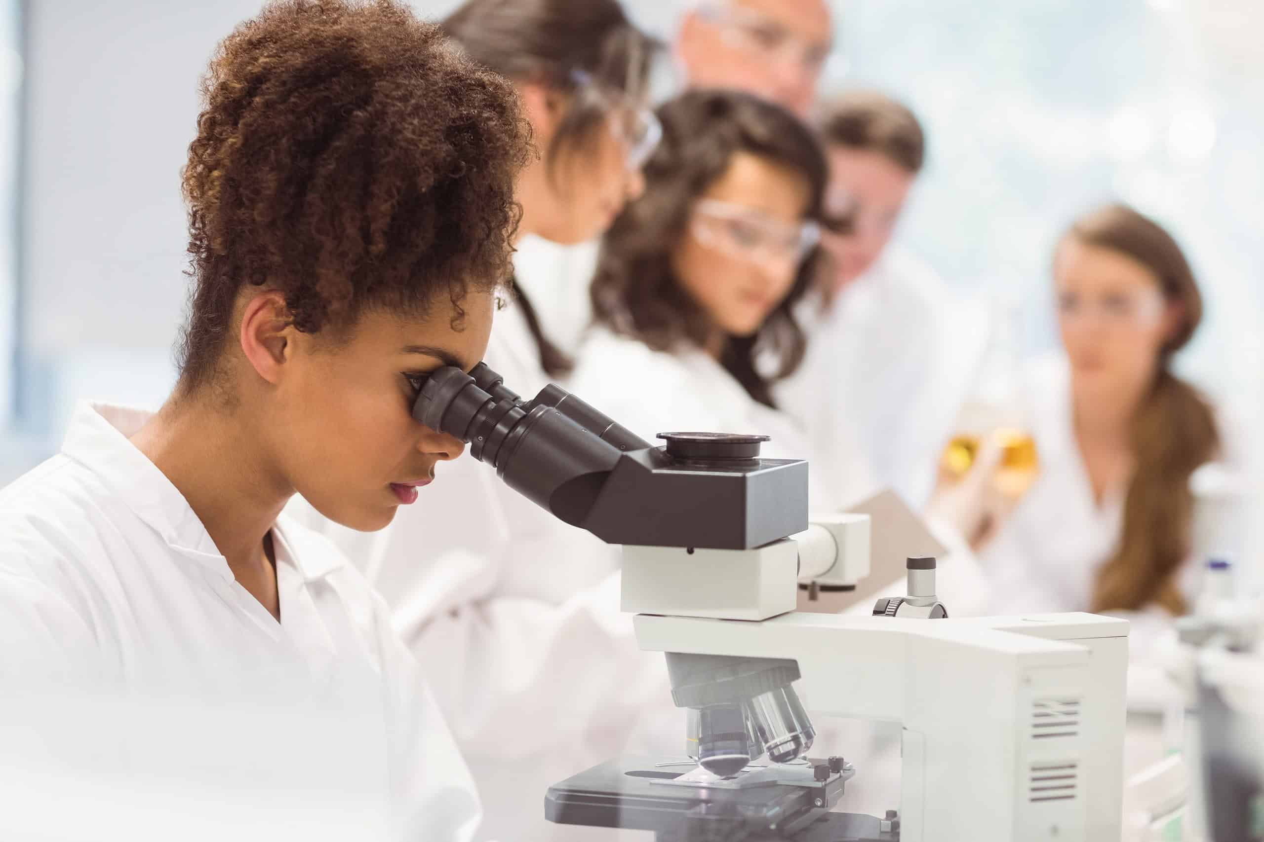 woman looking in a microscope
