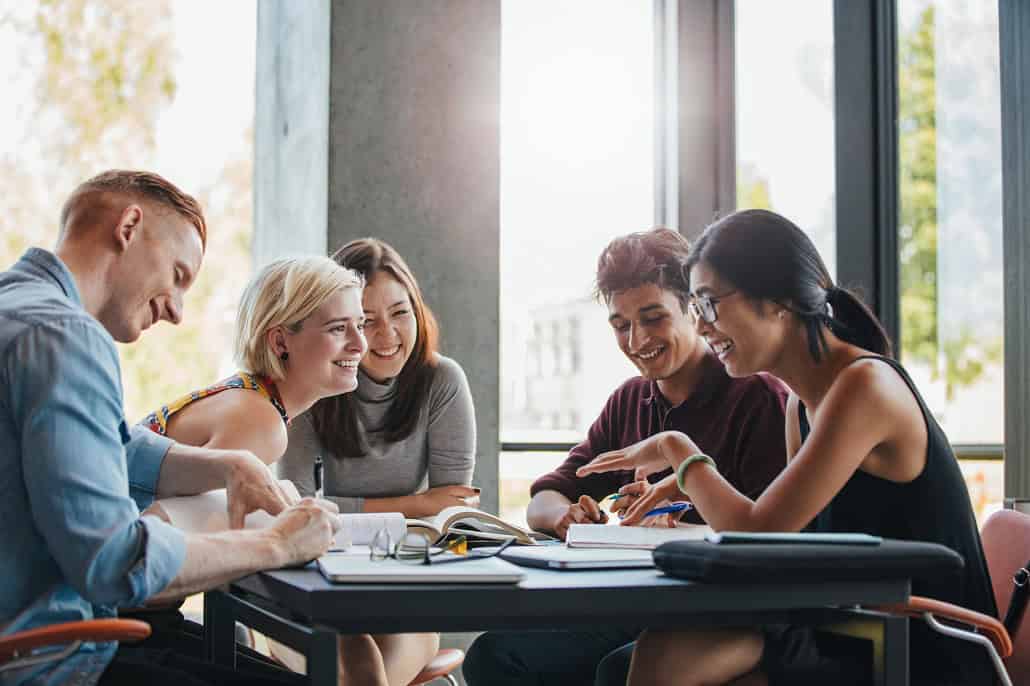 group of students talking at a table