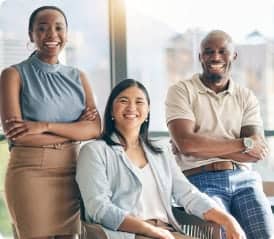 Three professionals smiling at the camera